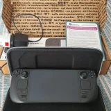 Steam Deck OLED 512GB — wallet, laptop, Polaroid camera (photo 1)
