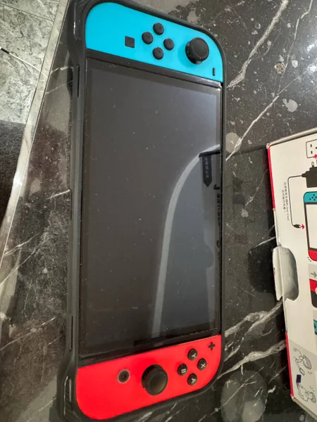 Nintendo Switch OLED Neon Blue/Red — moving van