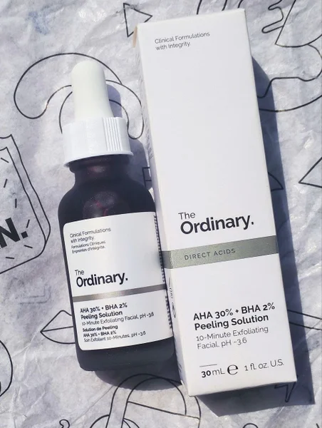 The Ordinary AHA 30% + BHA 2% Peeling Solution — wine bottle, lotion, red wine
