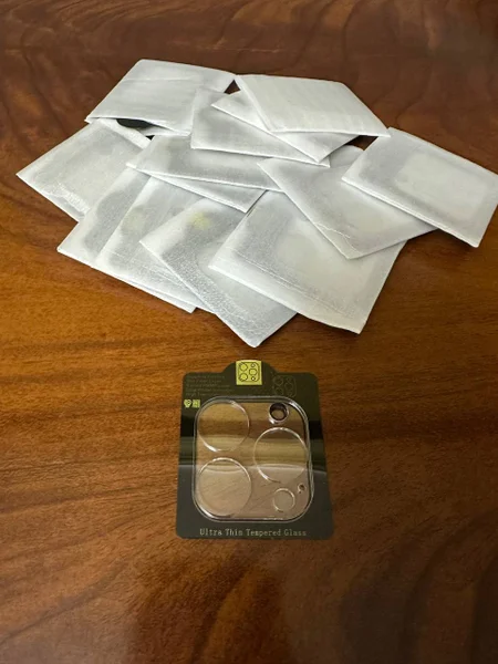 Защитное стекло на камеру для iPhone 14 Pro Max — handkerchief, packet, can opener